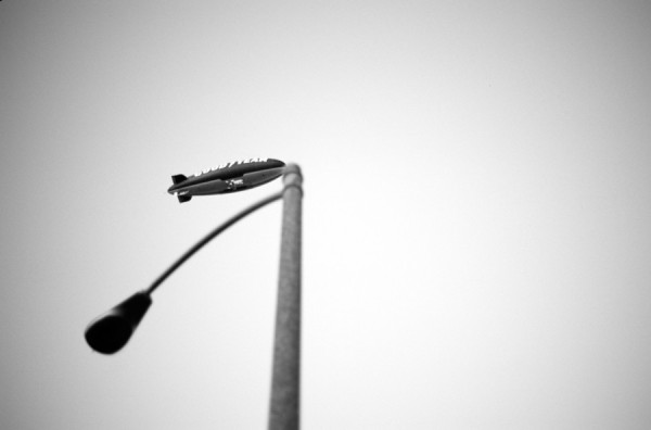 perspective askew photo of a Goodyear blimp mooring on a lamp post
